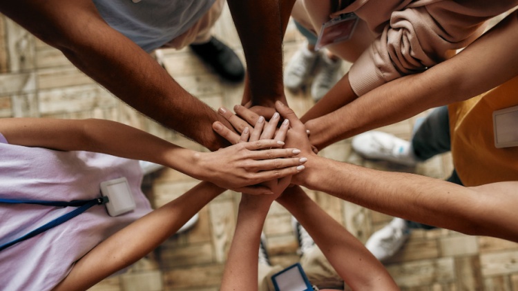 People in a circle putting their hands together